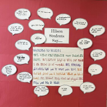 A red background with handwritten text explaining the way the office can help visitors, students and staff at Hilson PS